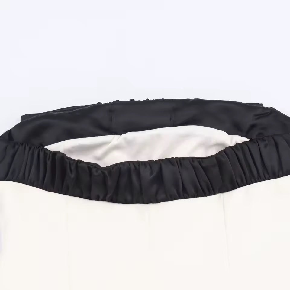 Vestido Malba empalmado con lazo negro y cuello oblicuo